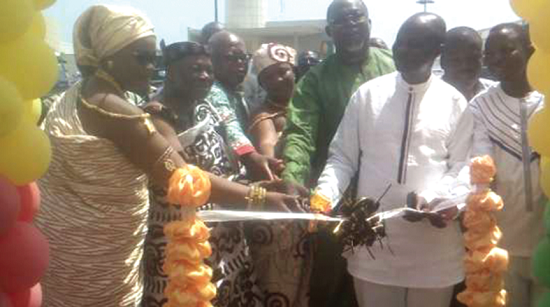 Mr Ekwow Spio-Garbrah (in green) being assisted by other diginitaries to cut the tape to open the fair Mr Ekwow Spio-Garbrah (in green) being assisted by other diginitaries to cut the tape to open the fair